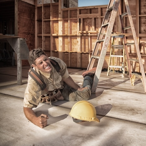 Carpenter building a home at construction site. Falling off ladder. Injured leg. concept of mistakes to avoid when filing a workers' comp claim