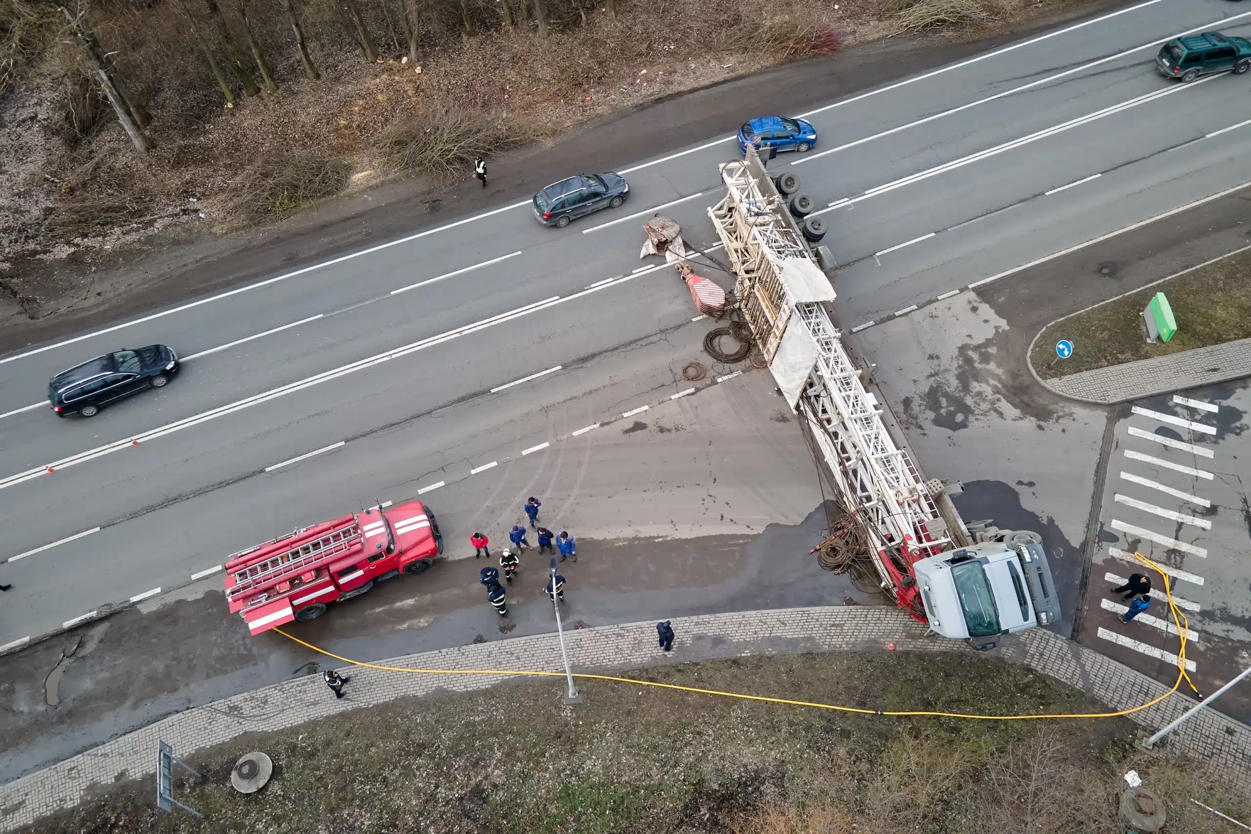 Overturned crane truck with emergency responders on Illinois roadway.